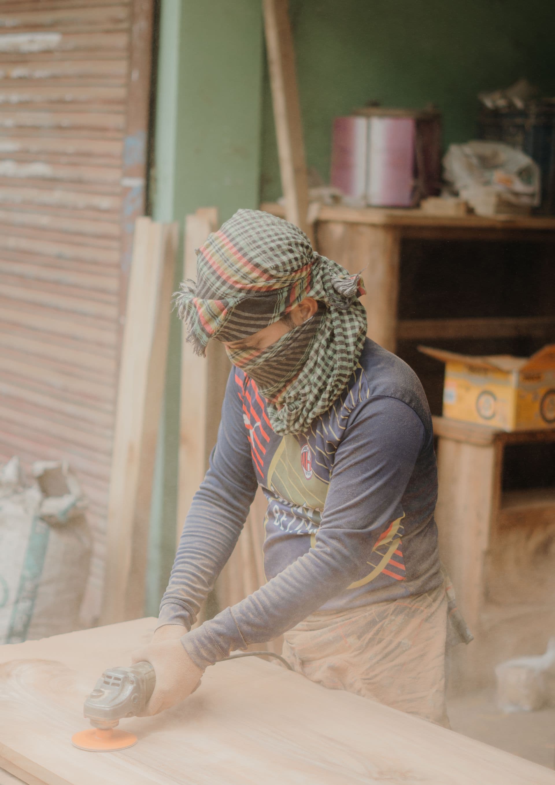 Carpenter hand-planing hardwood in a timber workshop