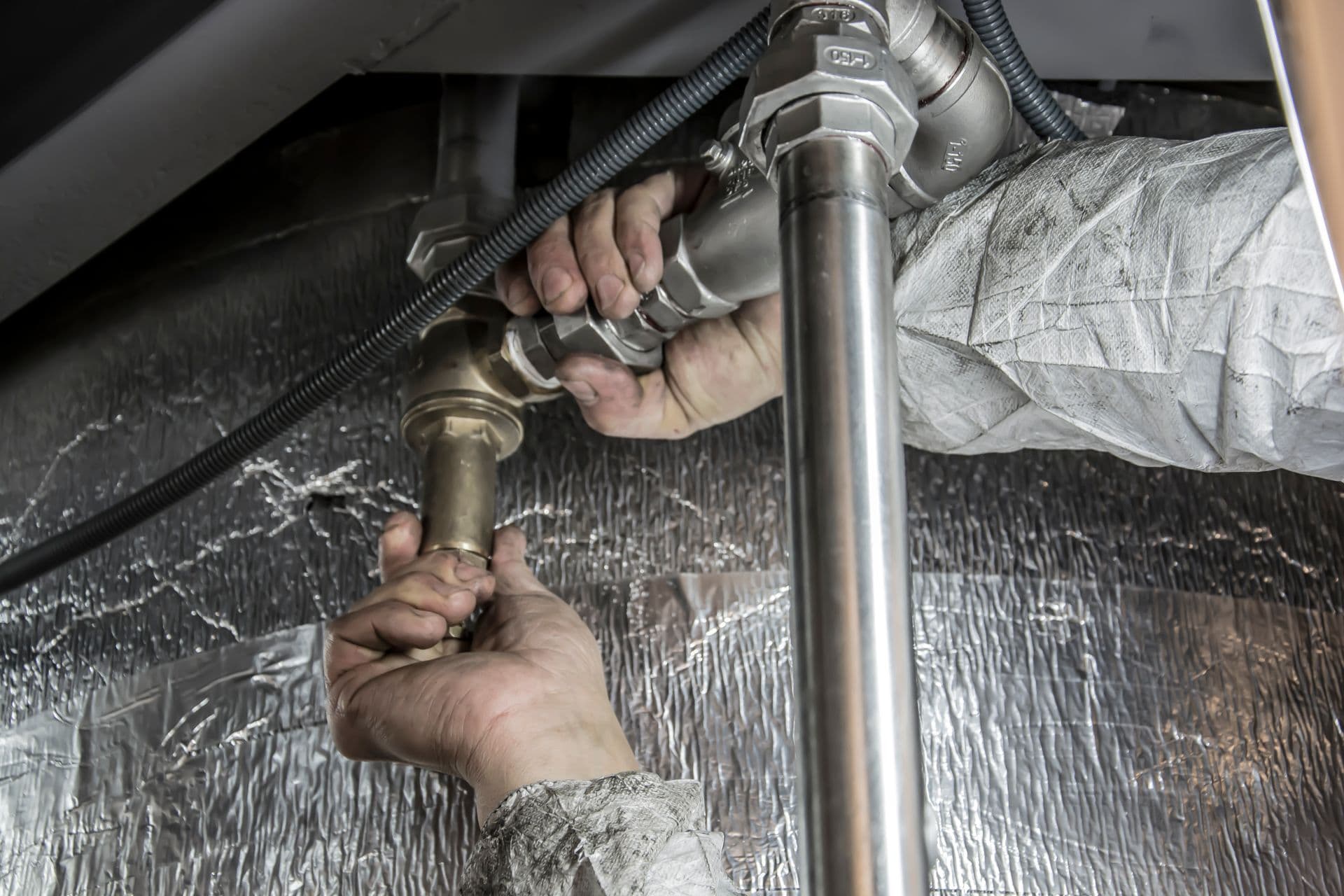 Plumber feeding an inspection camera into a drain